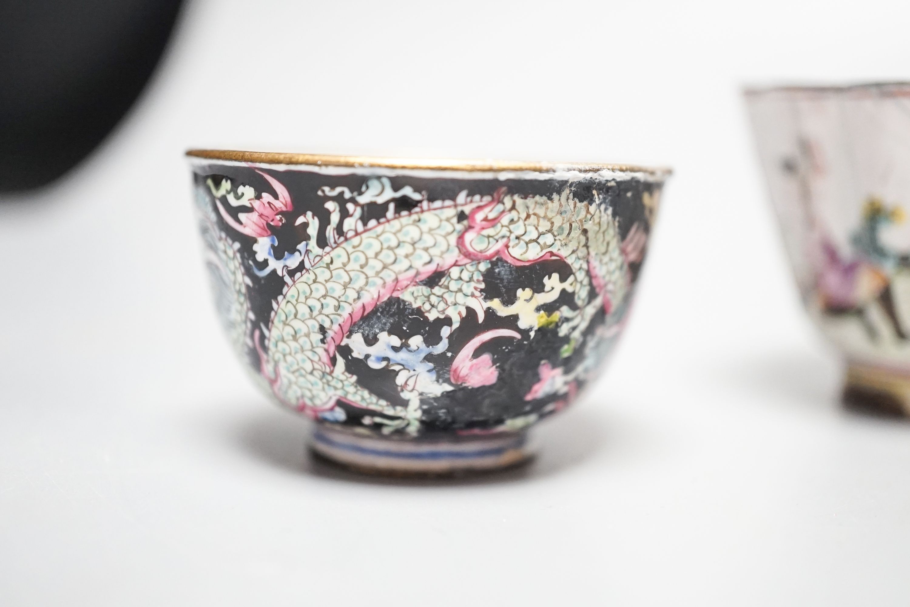 Two 18th century Chinese Canton enamel cups, and a 19th century Canton enamel oval snuff box, 5.8cm